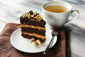 Plate with tasty pistachio cake on table