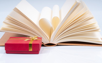Book and red box gift with educational concept
