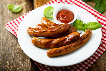Grilled sausages with tomato sauce