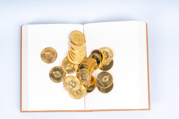 Book and cryto coins with education concept