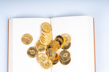 Book and cryto coins with education concept