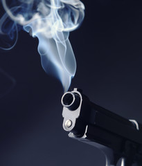 Smoking gun on dark background