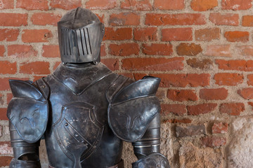 Knight armour against brick wall background