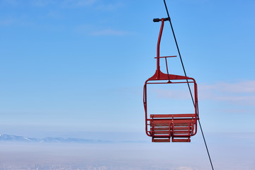 Empty old wooden chairlift against blue sky. Brasov, Romania.