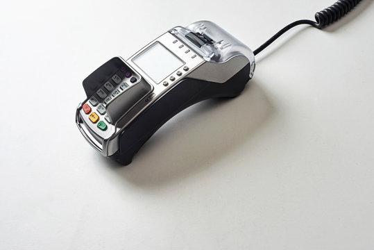 Credit card reader on white table background.