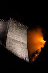 The old tower of Mesocco Castle on fire