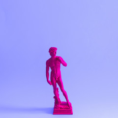 Creative concept of purple neon David is a masterpiece of Renaissance sculpture created  by...