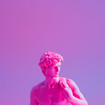 Creative concept of purple neon David is a masterpiece of Renaissance sculpture created  by Michelangelo. Vaporwave style  .