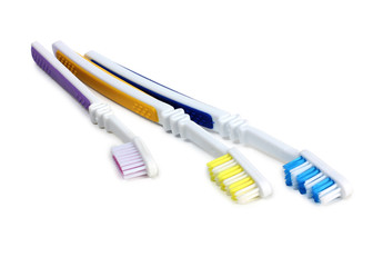 Toothbrushes and tube on white background