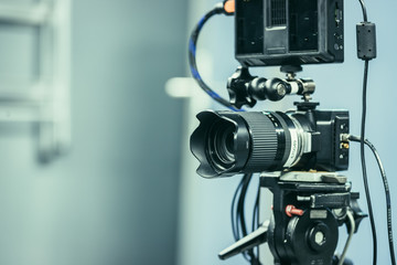 Fototapeta na wymiar Professional film camera on a tripod in broadcasting studio