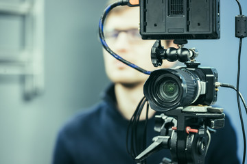 Professional film camera on a tripod in broadcasting studio