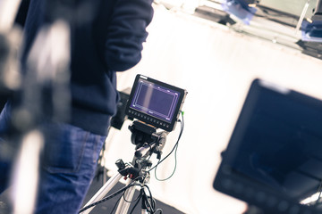 Cameraman operates a film camera, broadcasting studio