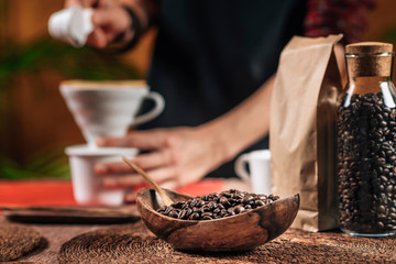 Fototapeta na wymiar Coffee Grains in a Wooden Bowl