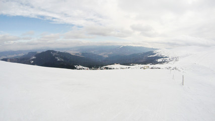 Fototapeta na wymiar Winter in the mountains. Snowy slopes. Ski slopes Svidovets spine. Dragobrat Ukraine