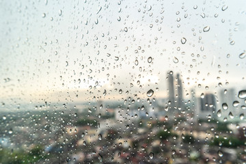 Raindrops on window glass with blur background