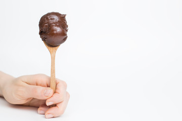 Spoon with chocolate Nutella cream on a white background. 