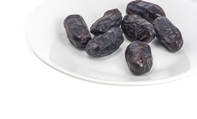 A stack dry dates at white plate