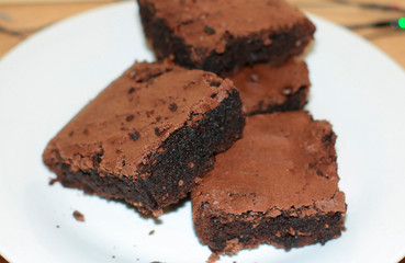 fresh flavored chocolate brownies on a white plate