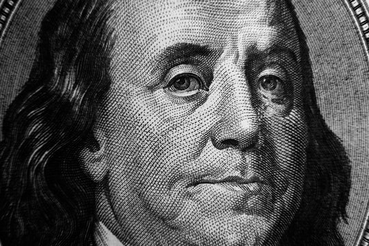 Benjamin Franklin on a dollar bill close up. Businessand finance concept.