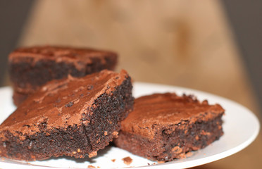 fresh flavored chocolate brownies on a white plate