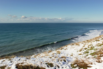 snow-covered beach, sea and blue sky