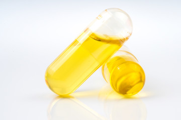 Olive capsule with white background.