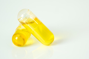 Olive capsule with white background.