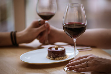 lovers boy and girl hold glasses in their hands in a cafe 4