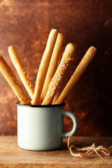 Grissini in vintage iron mug, bread sticks  