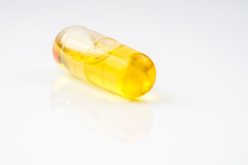 Olive capsule with white background.
