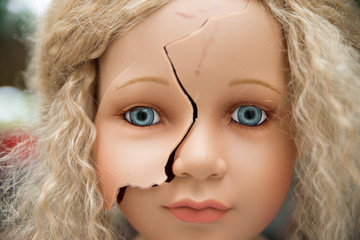 Blonde doll has a broken face, mannequin destroyed