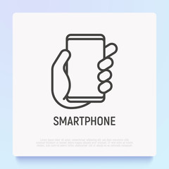 Smartphone in hand thin line icon. Modern vector illustration.