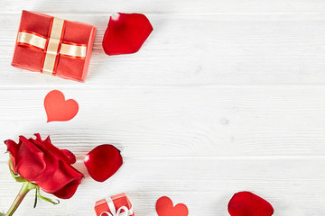Happy Valentine's day concept. Close up composition with presents wrapped in colorful paper and tied with satin bow, traditional lovers day holiday attributes. Copy space, background, top view.