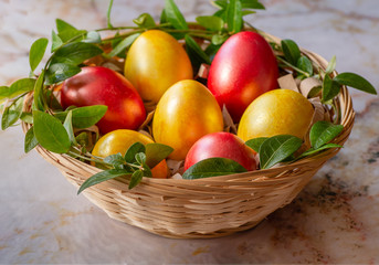 Colorful easter eggs in a basket. Easter eggs on marble background.