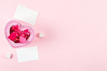 Happy Valentine's day concept. Close up composition with presents wrapped in colorful paper and tied with satin bow, traditional lovers day holiday attributes. Copy space, background, top view.