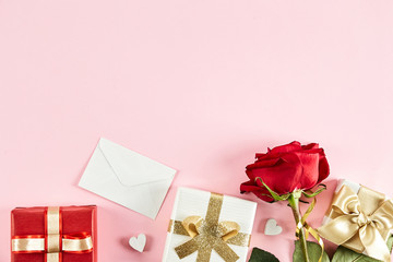 Happy Valentine's day concept. Close up composition with presents wrapped in colorful paper and tied with satin bow, traditional lovers day holiday attributes. Copy space, background, top view.