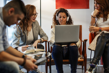 Group of students study in the school campus library.Learning and preparing for university exam.