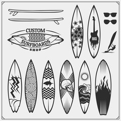 Set of different surfboards. Vector illustration. Surfing emblems, icons and labels. - obrazy, fototapety, plakaty