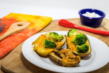 Potato Skins appetizer with broccoli, cheddar cheese and fried onions
