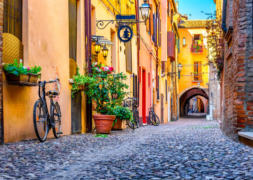 Fototapeta Cozy narrow street in Ferrara, Emilia-Romagna, Italy. Ferrara is capital of the Province of Ferrara