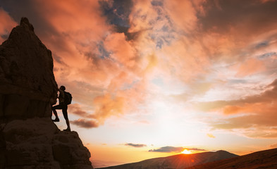 silhouette of successful climbing woman in mountains Concept of concept of motion motivation inspiration at beautiful sunset