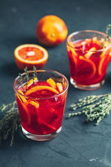 Red orange juice in a large glass on dark concrete background