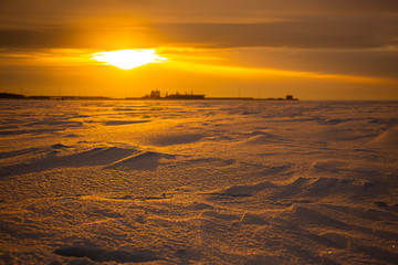 Sunset on the Neva Bay in winter