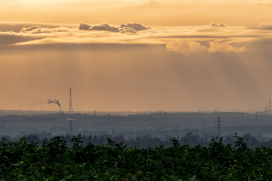 Cloud formations from Langdon Hills, Essex. with the Sun behind the clouds and Kent in the distance.