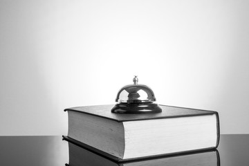 Book and bell with yellow background