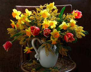 Still life with a bouquet of tulips and daffodils