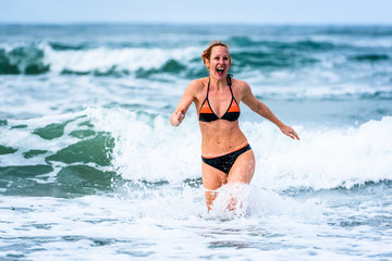 Woman enjoying the sea and waves of Atlantic ocean.