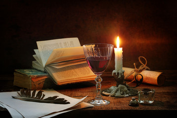 Naklejka na ściany i meble Glass of red wine and a candle