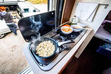 Cooking dinner or lunch in campervan, motorhome or RV.