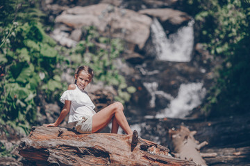 Little girl enjoying view of waterfall in Krasnay Poliana